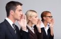 Global gossiping. Side view of three attractive young business p Royalty Free Stock Photo