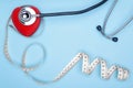 Global healthcare concept.Stethoscope and decorative red heart on a blue background doctor.Heart and statoscope close-up on a blue