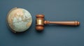 Gavel striking a globe representing global law and international justice Royalty Free Stock Photo