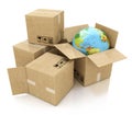 Global logistics, shipping and worldwide delivery business concept: Earth planet globe and heap of stacked corrugated cardboard b