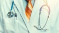 Global Medicine Healthcare Insurance Concept. Unrecognizable doctor with stethoscope, close-up front view toned image