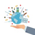 Global pharmaceuticals. Hand hold earth globe with pills vaccines and drugs, different bottles and syringes, world