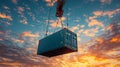 Global Shipping And Logistics Blue Cargo Container Lifted By Crane Against Dramatic Sunset Sky Royalty Free Stock Photo