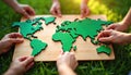 Global teamwork unites for environmental conservation. People collaborate assembling green world map puzzle on grass. Community Royalty Free Stock Photo