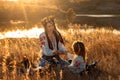 Global view, real life around the globe, local living. Mom and daughter in national clothes and flower wreaths are Royalty Free Stock Photo