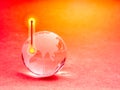 Global warming and climate change concept. Hot weather thermometer with arrow on high temperature symbol on glass earth globe on Royalty Free Stock Photo