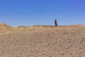 Global warming climate changes concept landscape photography of lonely female person in the middle of desert scenic dry ground