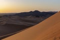 Global warming concept. Lonely sand dunes under dramatic evening