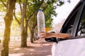 Global warming environmental protection concept,Woman hand holding plastic bottle on the road Royalty Free Stock Photo