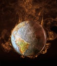 Global warming illustrated with flames surrounding the earth,