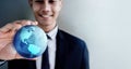 Globalization Concept. Happy Smiling Professional Businessman holding a Transparent Blue World Globe