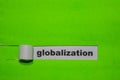 Globalization, Inspiration and business concept on green torn paper