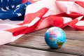 Globe and American flag on wooden background. Royalty Free Stock Photo