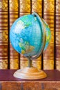 Globe on the background of pile of vintage books