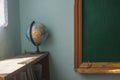 globe on a book shelf near an old school board Royalty Free Stock Photo