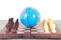 Globe and chess pieces on both sides Royalty Free Stock Photo