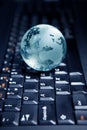 Globe on the computer keyboard Royalty Free Stock Photo