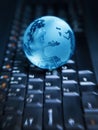 Globe on the computer keyboard Royalty Free Stock Photo