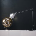 Globe created of euro coin unser the desk lamp light 3d render