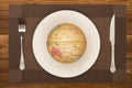A globe on a dish with fork and knife nearby concept of overusing the resource of nature