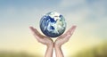 Globe , earth in human hand, holding our planet glowing.  image provided by Nasa Royalty Free Stock Photo