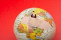 Globe Earth with a man figurine plaster banded aid on