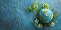 A Globe in Earth with Small Green Flowers on a Blue Background Royalty Free Stock Photo