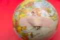 Globe Earth with a woman figurine plaster banded aid on