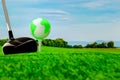 Globe on golf ball on green grass.