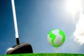 Globe on golf ball on green grass Royalty Free Stock Photo