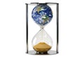 Globe inside hourglass with sand running out symbolizing time and earth Royalty Free Stock Photo