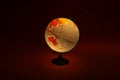 Globe or map of the world lamp glowing with illumination in the dark Royalty Free Stock Photo