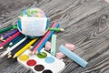 Globe with medical mask. Nearby watercolors, crayons and pencils. Academic year during the epidemic Royalty Free Stock Photo