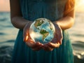 The globe is a model of the blue planet Earth with continents and seas in caring female hands