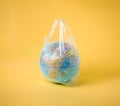 Globe model in plastic bag, save the world