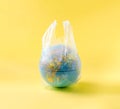 Globe model in plastic bag, save the world