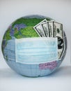 Globe with money covered with respiratory mask - Covid 19 Royalty Free Stock Photo