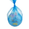 Globe of planet Earth dressed in a garbage plastic bag isolated on white.