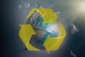 Globe of planet Earth in a garbage bag. Yellow recycling sign. The concept of conservation of the environment and its resources,