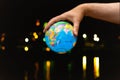Globe planet Earth in the hands of man against the night city. Concept of ecology and media. Earth night background Royalty Free Stock Photo