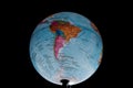 Brazil - March 2020. Globe with Russian geographical names isolated on black bacground Royalty Free Stock Photo