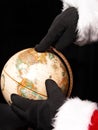Globe with Santa'a Hands Pointing the Way Royalty Free Stock Photo