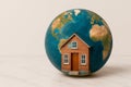 A globe with a small house on the surface. Space for text. Royalty Free Stock Photo