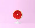Globe sphere orb,Grapefruit slice on pastel pink background. min