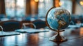 Globe on a Table in a Conference Room with Culturally Diverse Elements Royalty Free Stock Photo