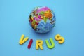 Globe and text VIRUS on a blue background. Coronavirus / Corona virus concept. The spread of corona virus in the World Royalty Free Stock Photo
