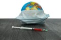 The globe and vaccination. The World epidemic of coronavirus. Earth Vaccination. An injection against the virus