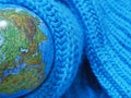 Of the globe was wrapped in a turquoise scarf knit