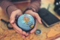 Globe, whole world in hands and compass, magnifying glass and book on route map on the table. Travel , Adventure and Discovery Royalty Free Stock Photo