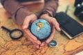 Globe, whole world in hands and compass, magnifying glass and book on route map on the table. Travel , Adventure and Discovery Royalty Free Stock Photo